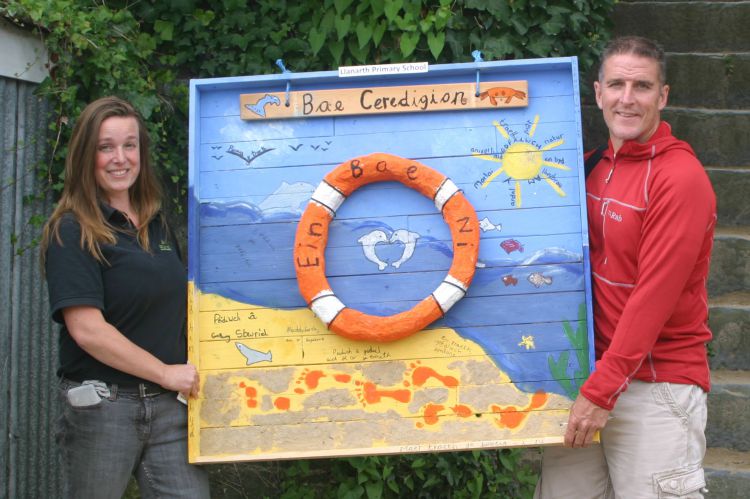 Iolo Williams and Morag from Celtic Sustainables with the winning artwork by Llanarth Primary School